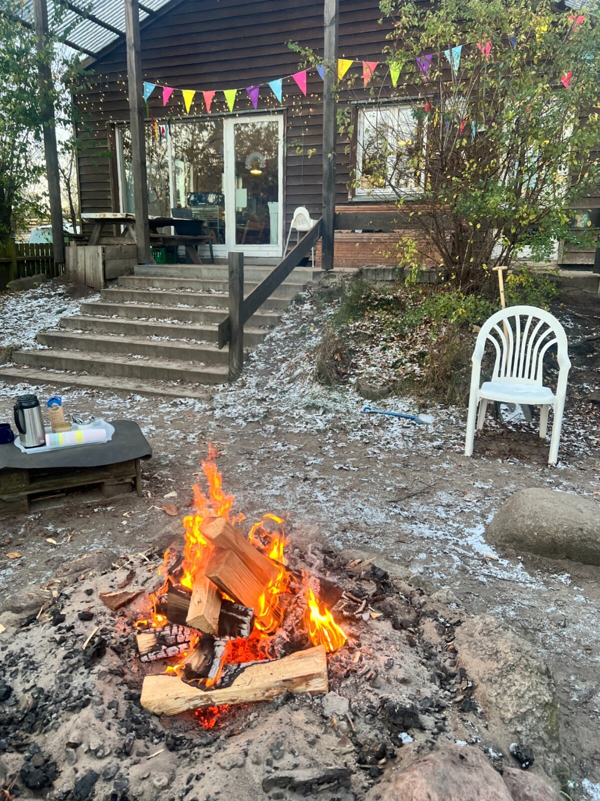Outdoor fire and wooden building at Dråbitten
